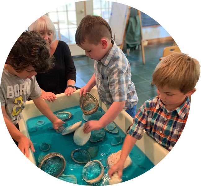 Kindergartners playing with the water table